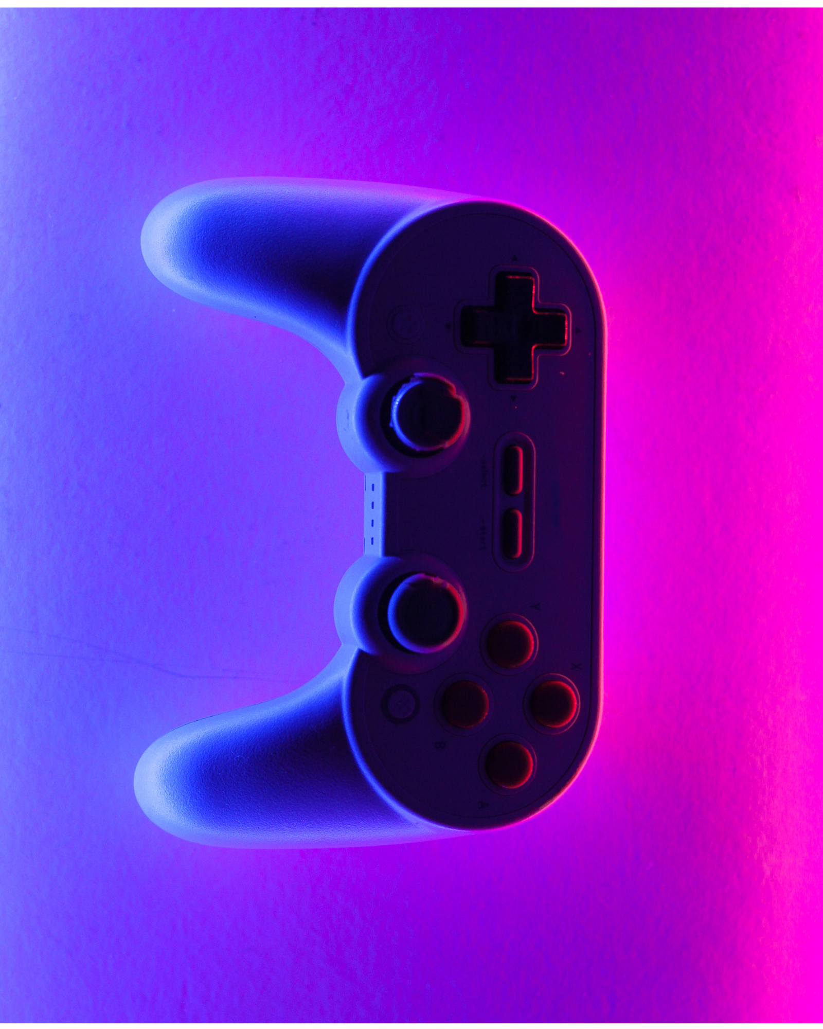  a modern gaming controller, prominently displayed against a dark background. The controller has an ergonomic design with curves for comfortable grip. It features standard buttons, analog sticks, and a directional pad, indicating it’s meant for comprehensive gameplay experiences. The object is illuminated by vibrant purple and blue lights from the sides, creating an aesthetic glow and emphasizing the controller’s shape. The background is dark which makes the colorful illumination stand out even more.