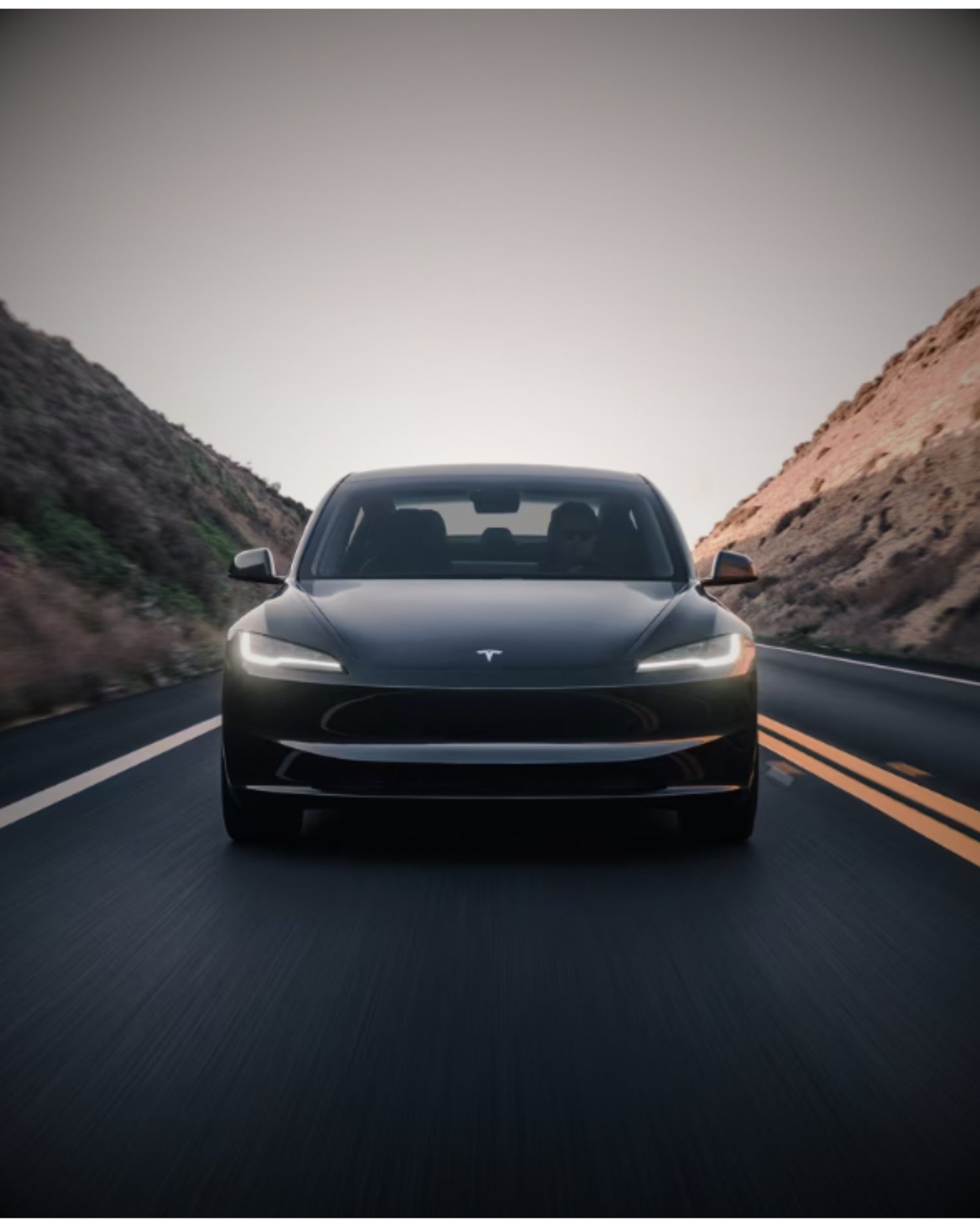 A sleek, black Tesla model y vehicle showcasing aftermarket accessories by Clevisco Automotive, captured in a dimly lit studio setting. The image highlights the car's enhanced sporty profile and high-quality customizations such as the distinctive wheel rims and subtle exterior trim, designed to complement the vehicle's aerodynamic lines.